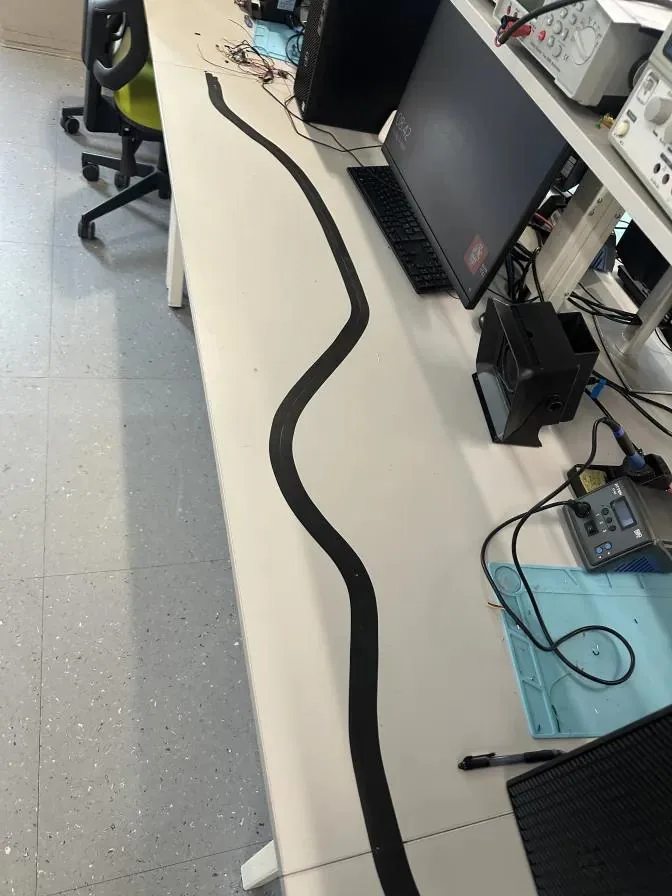 The line-following test track taped out on the bench