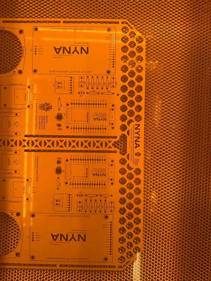 The PCB in orange solder mask