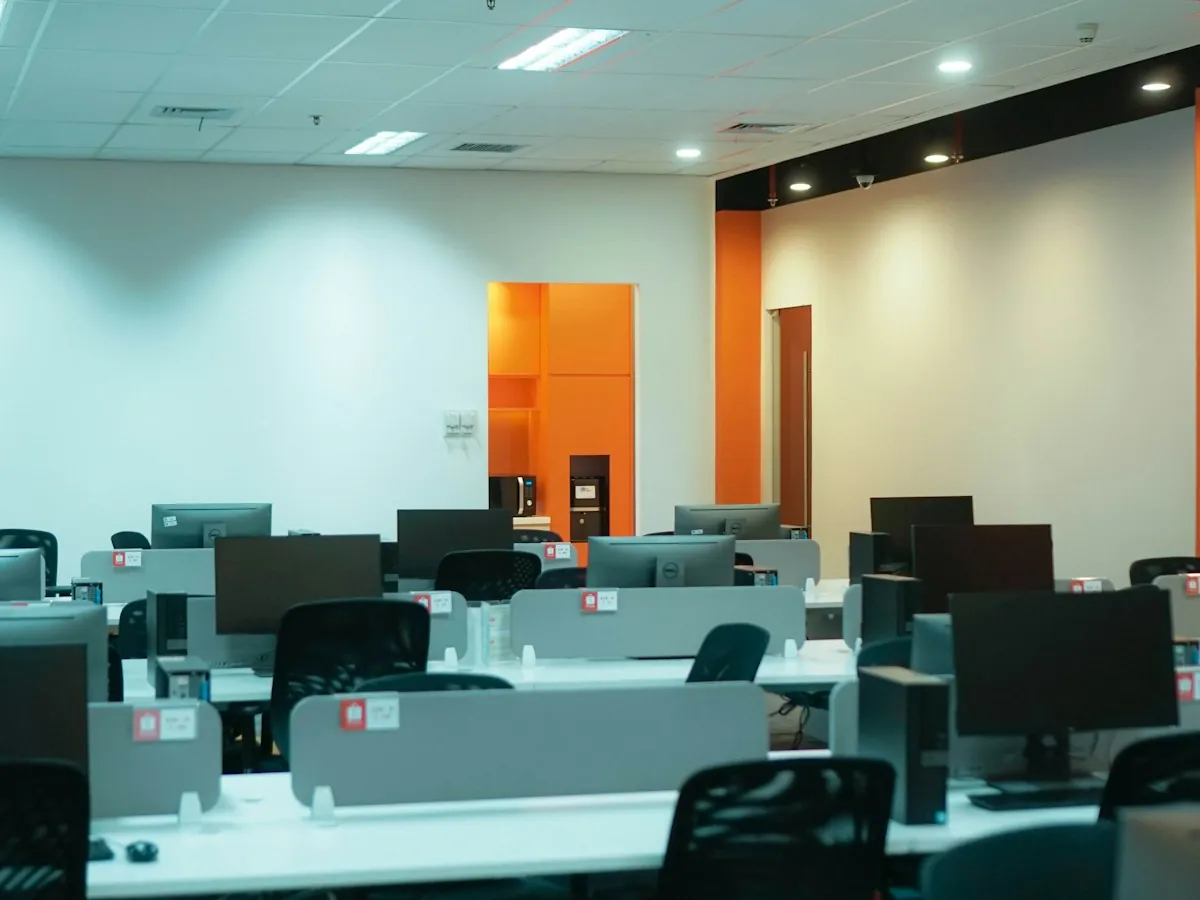 An office with rows of desks and computers