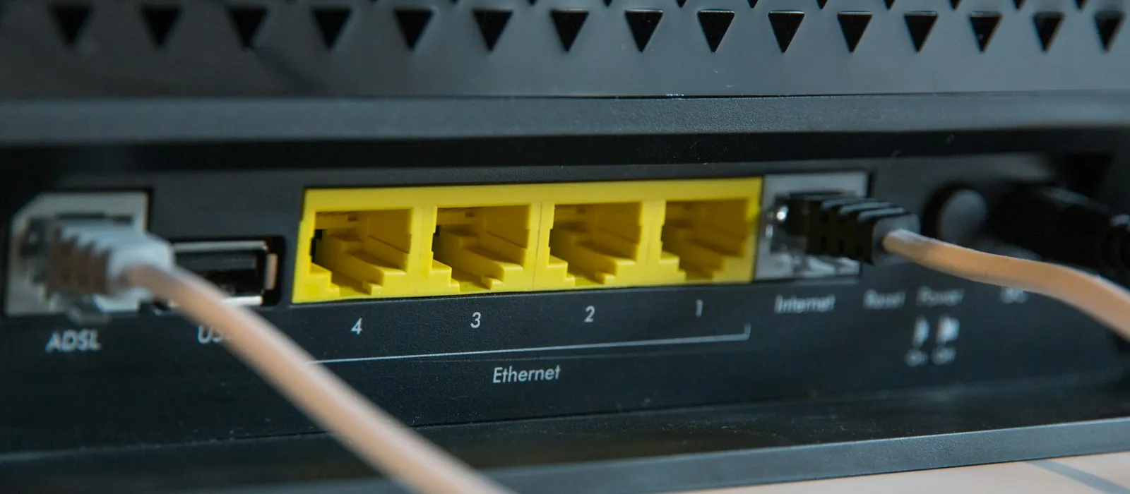 Network cables plugged into the ports of a router