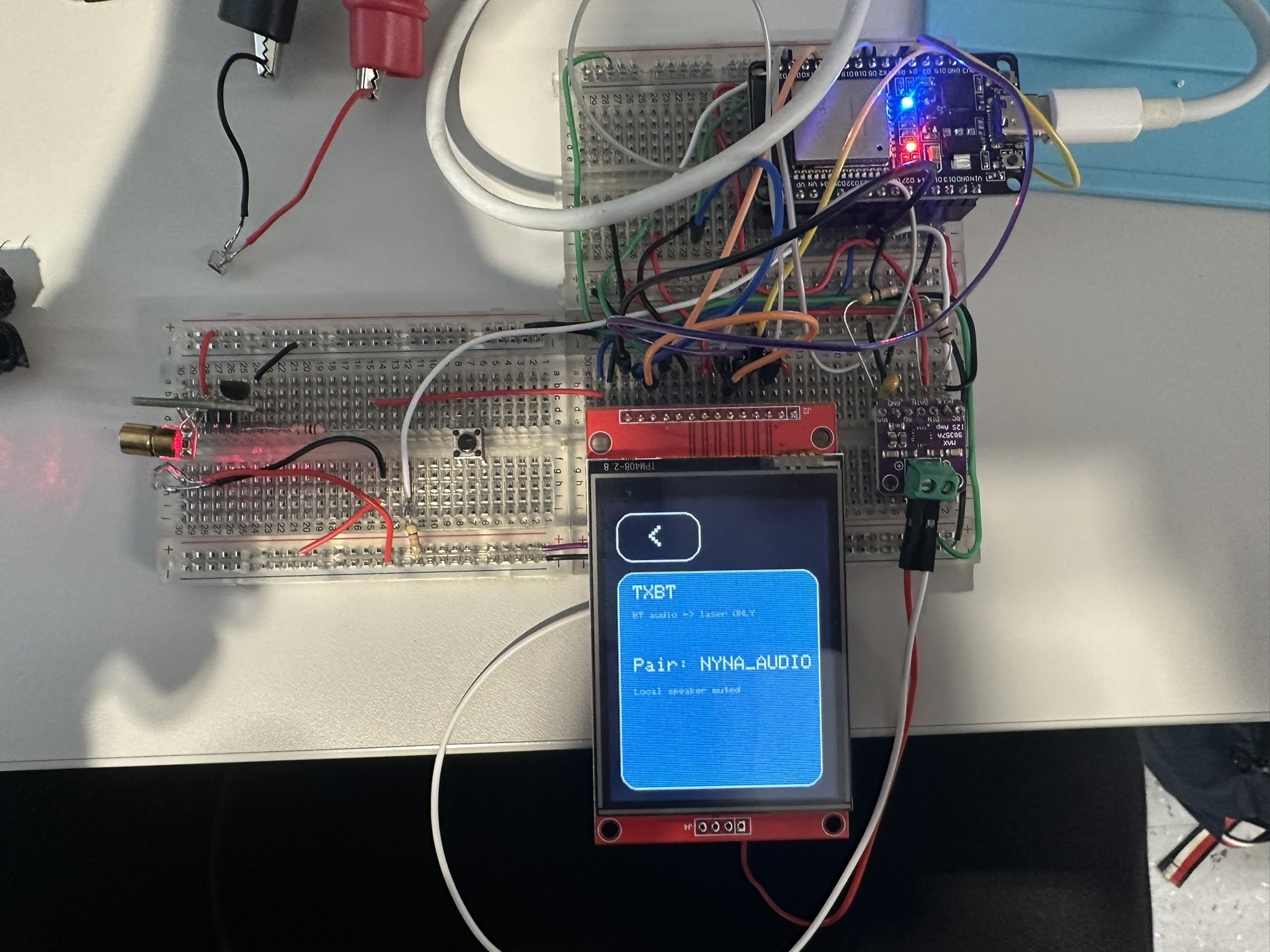 Breadboard transceiver prototype with 650nm laser and touchscreen showing NYNA_AUDIO pairing